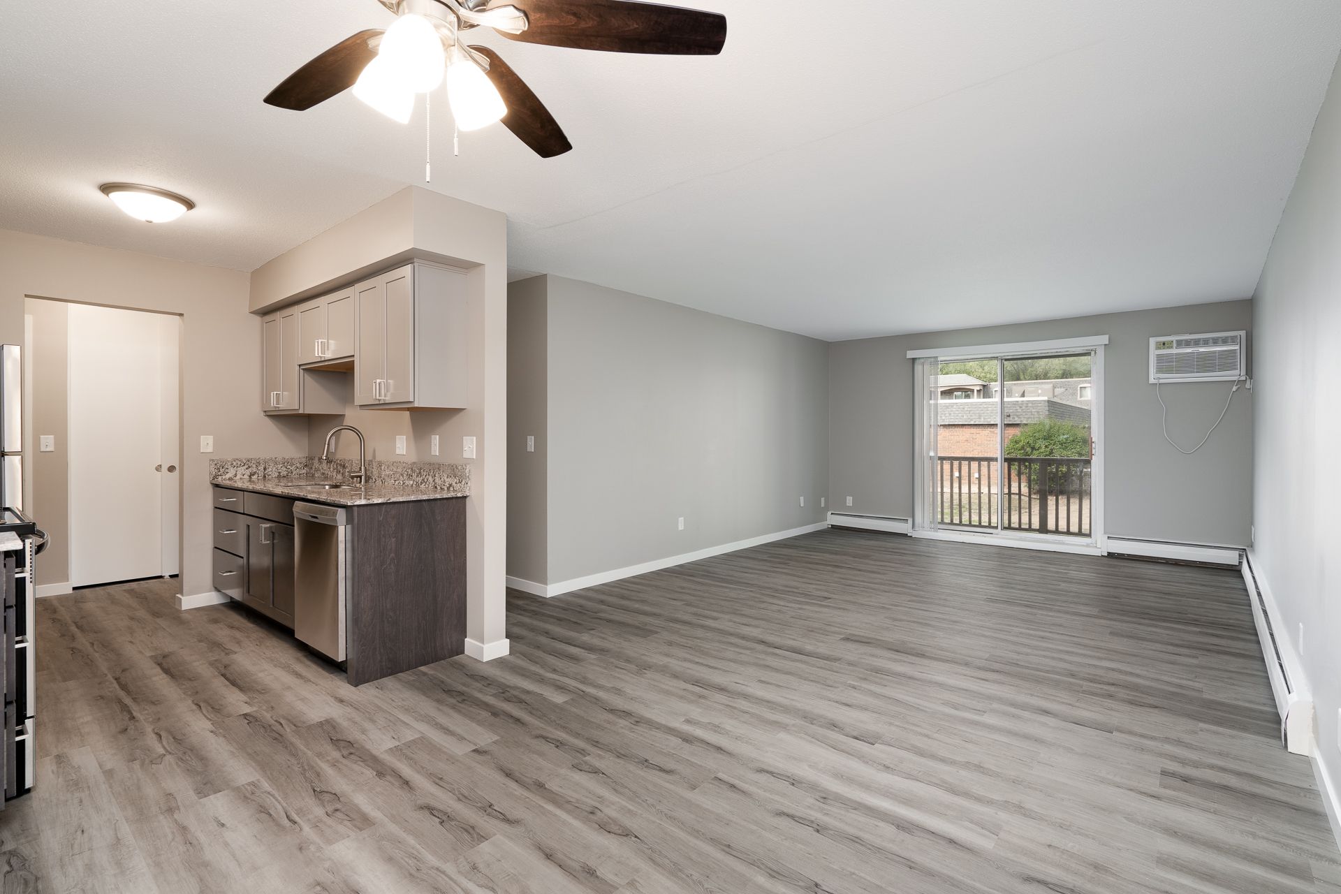 A living room with hardwood floors and a ceiling fan