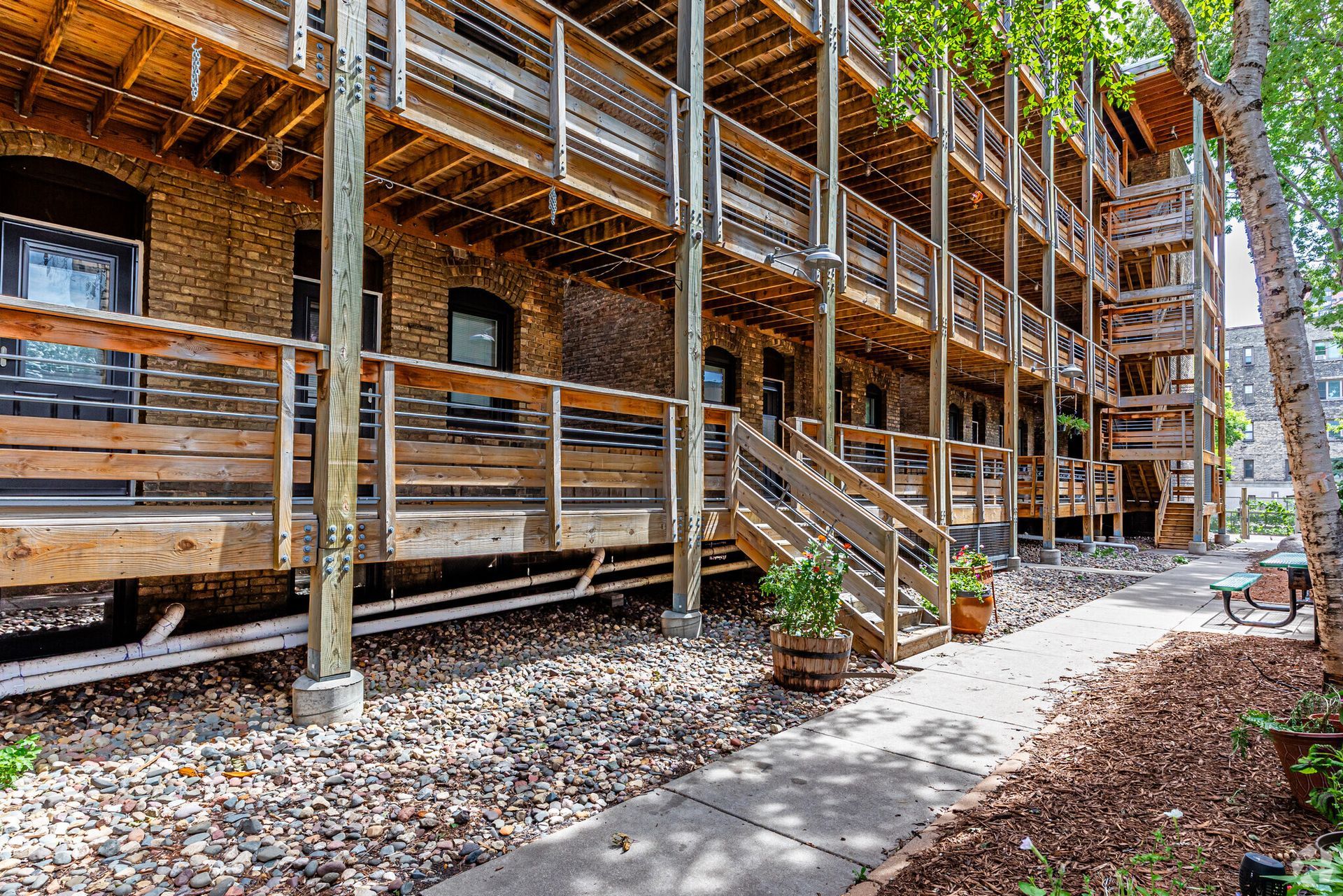 A large brick building with wooden decks and stairs leading up to it.