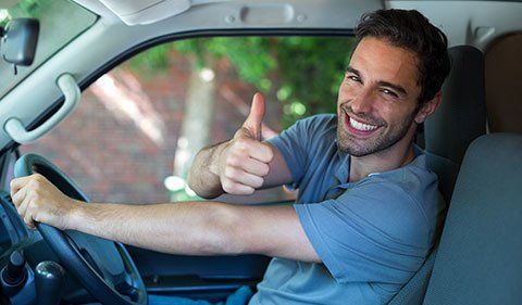 Man Showing Thumbs Pp While Driving — ABC Driving School in Central Coast NSW