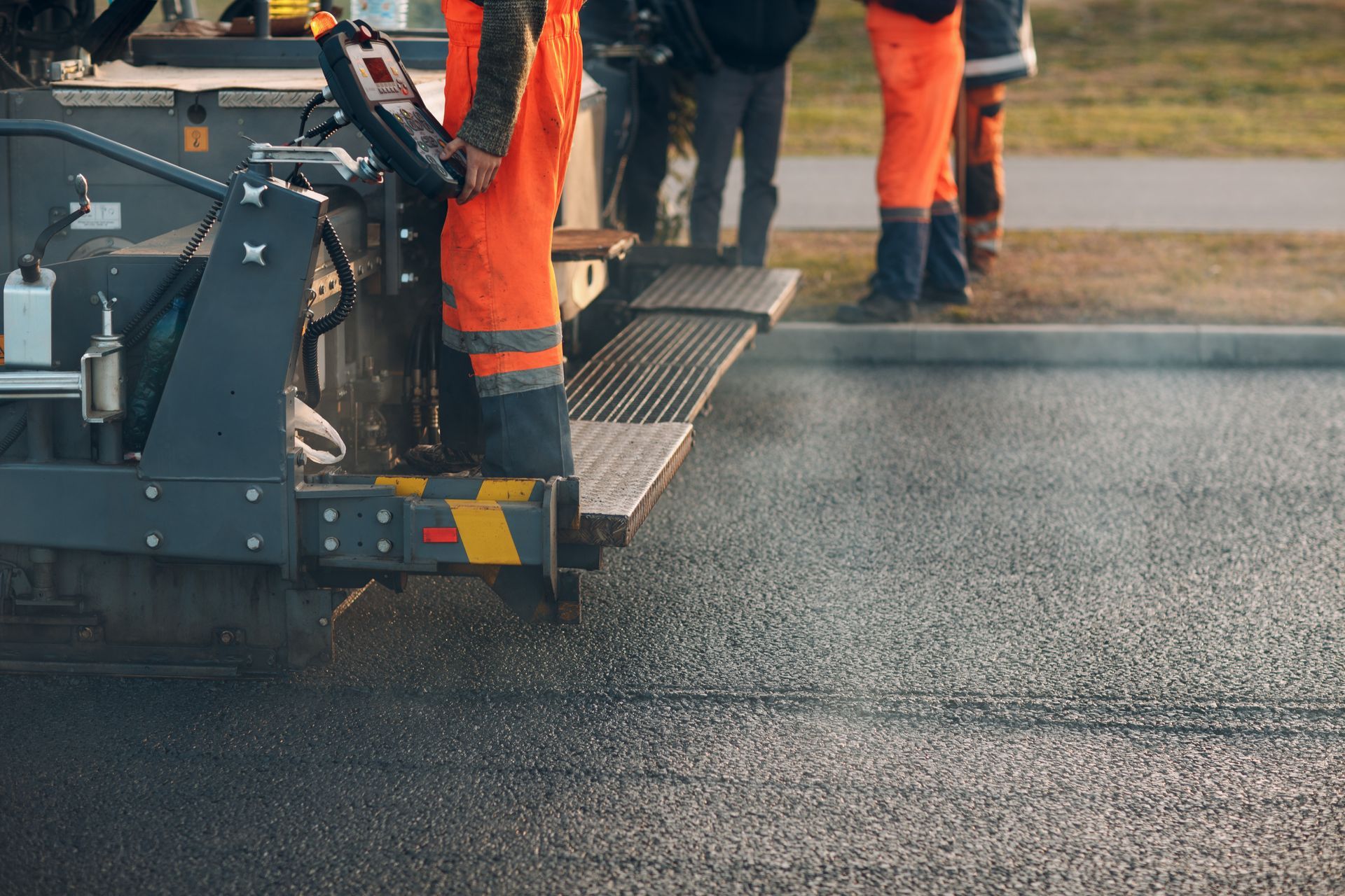 Asphalt paving crew operating machinery on a new roadway. Asphalt paving crew operating machinery on a new roadway.