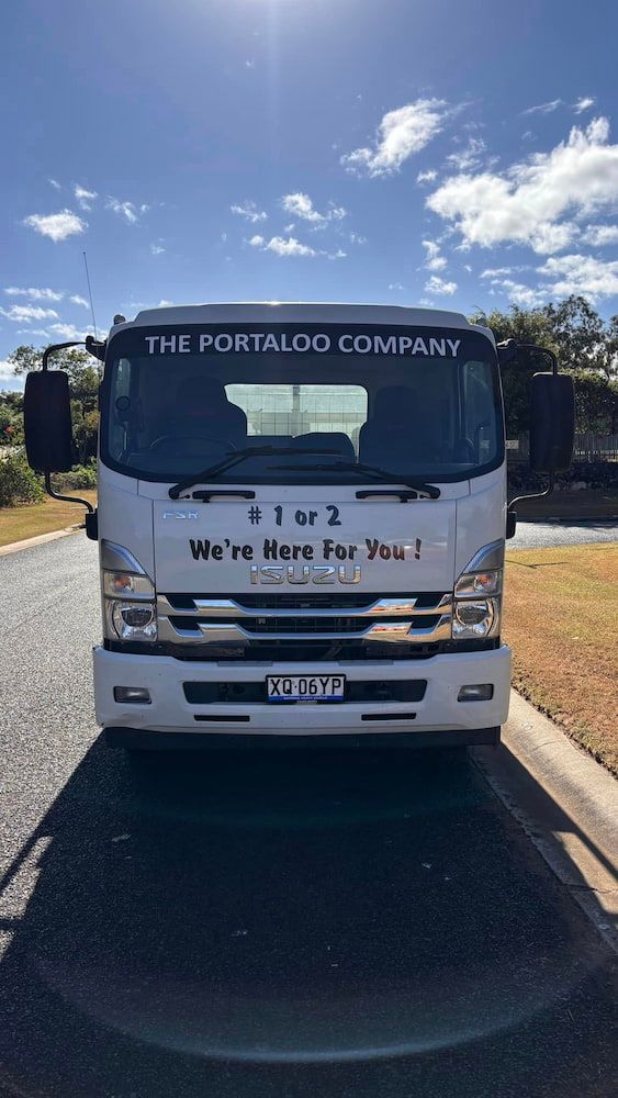 A White Truck Is Parked On The Side Of The Road — The Portaloo Co in Dimbulah, QLD