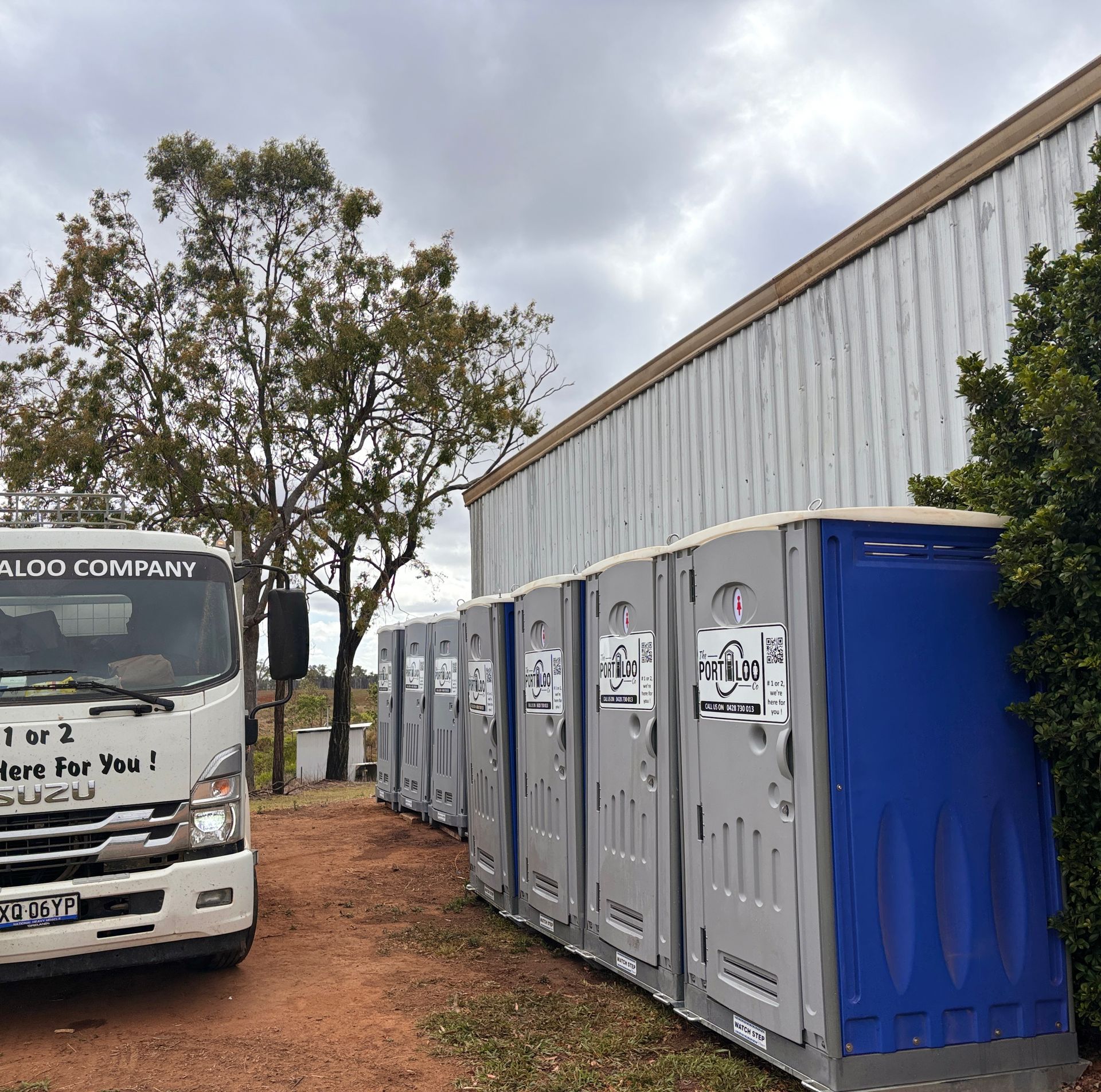 A Portable Toilet Is Sitting In The Middle Of A Grassy Field — The Portaloo Co in Dimbulah, QLD