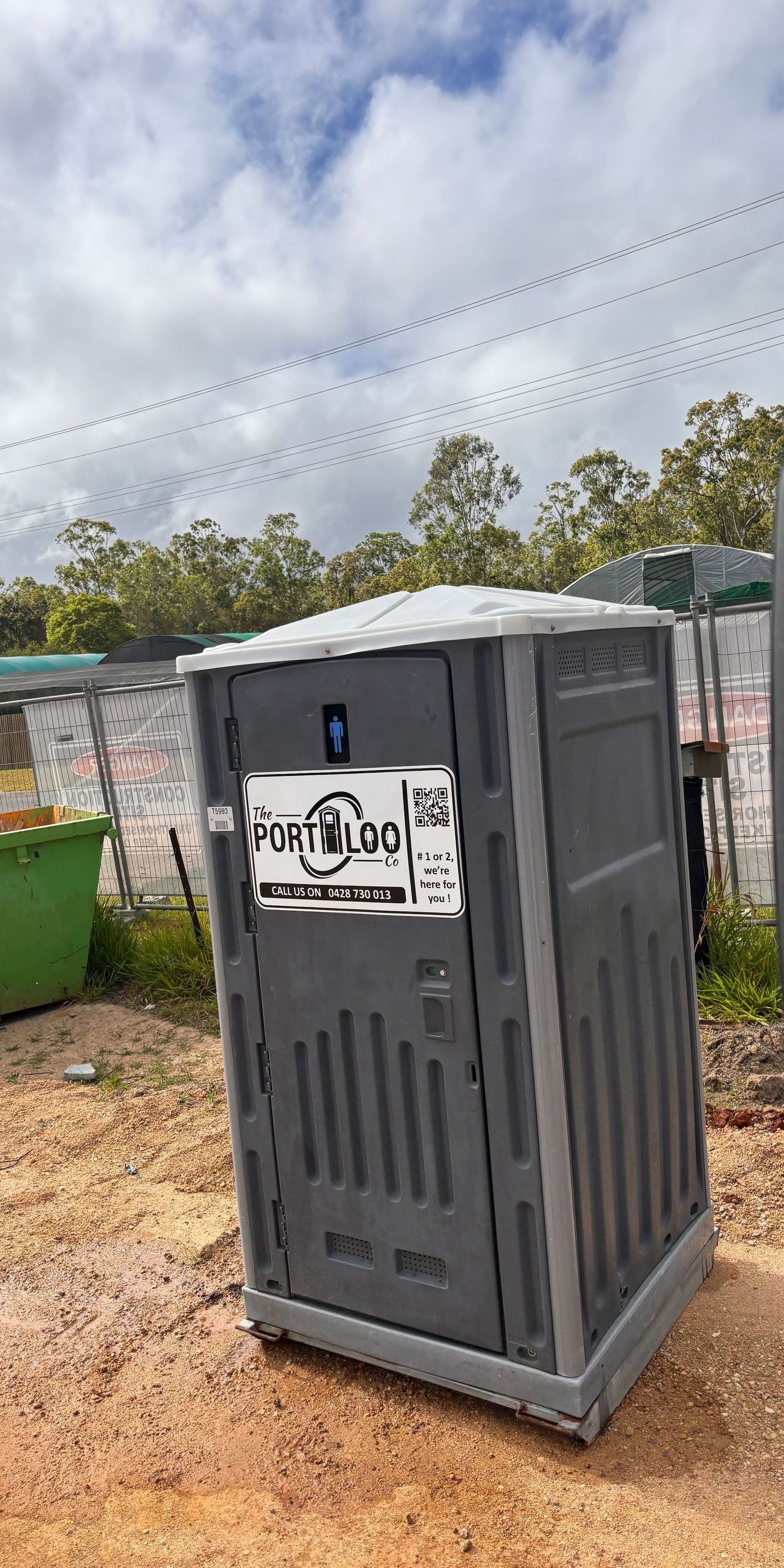 A Portable Toilet Next To Skip Bin — The Portaloo Co in Dimbulah, QLD