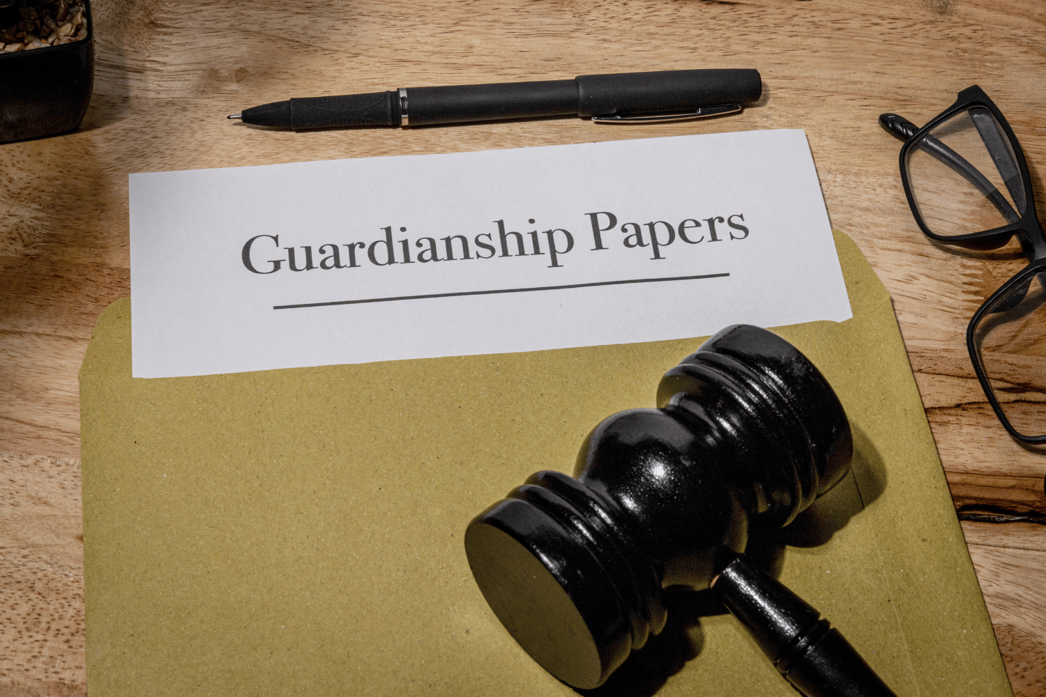 Beige two-story house with black roof and stone accents, two-car garage, on a lawn with a cloudy sunset.