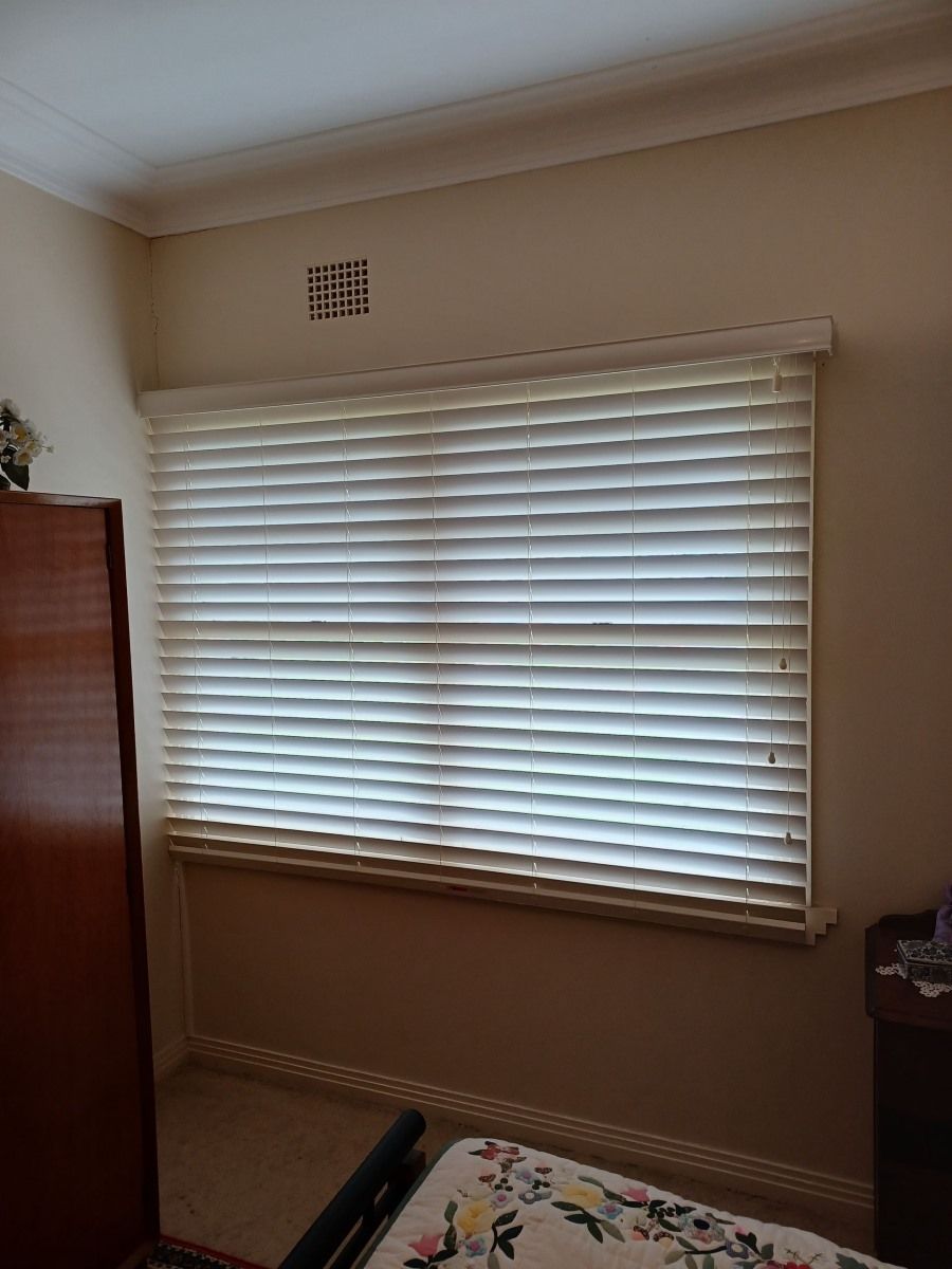 A Bedroom With a Large Window With Blinds on It — BTS Blinds & Awnings in Gunnedah, NSW