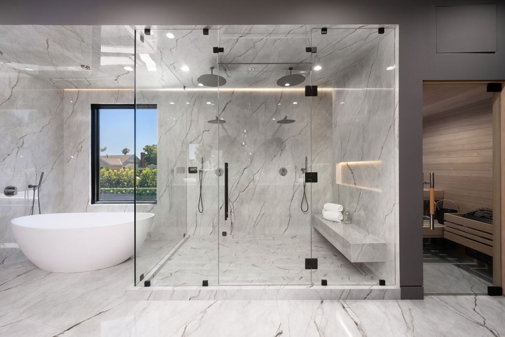 Luxurious bathroom with marble walls and glass shower, tub, and sauna.
