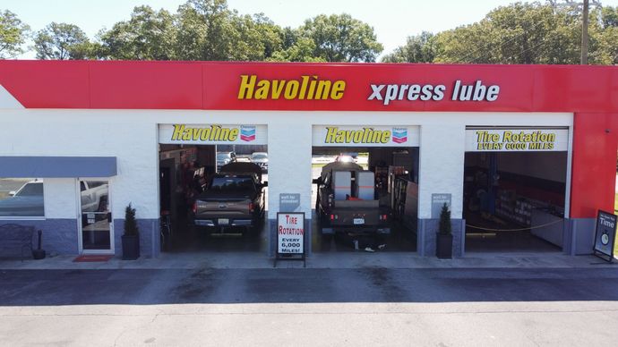 A havoline xpress lube garage with two cars inside