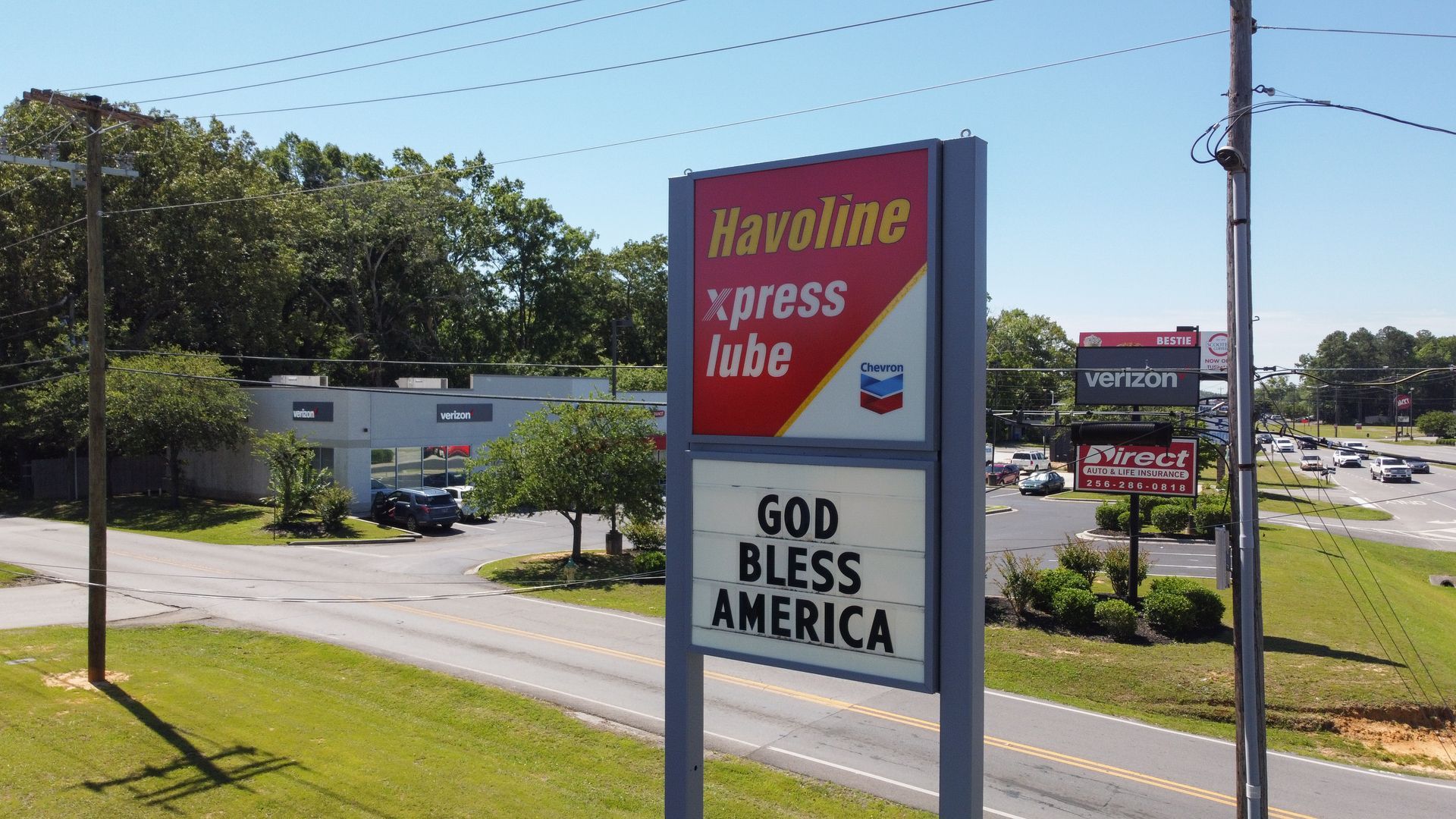 A sign for havoline express lube says god bless america