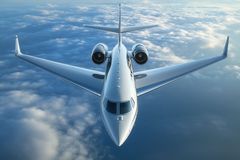 White private jet in flight, above clouds, viewed from directly below.