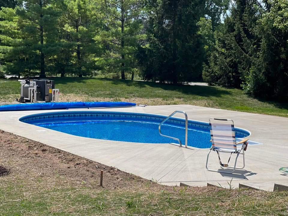 A swimming pool with a chair in front of it