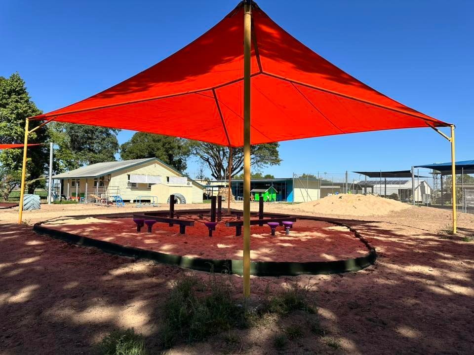 Red Shade Over Picnic Tables — Professional Shade Sail Installation in Caloundra, QLD