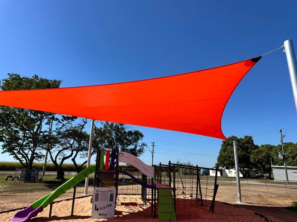 Red Shade Sail Over Playground — Professional Shade Sail Installation in Maroochydore, QLD
