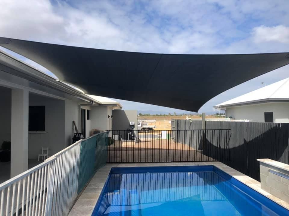 Home Pool Area Provided Cover by Shade Sail — Professional Shade Sail Installation in Garbutt, QLD