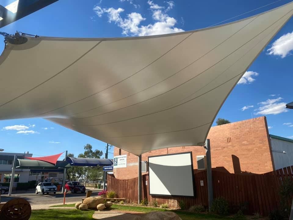 Large White Shade Sail Above a Pathway — Professional Shade Sail Installation in Townsville, QLD