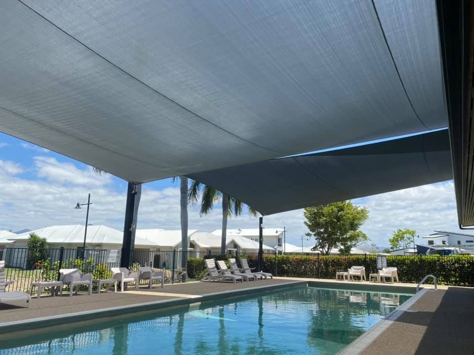 Pool Area Covered by Shade Sails — Professional Shade Sail Installation in Garbutt, QLD