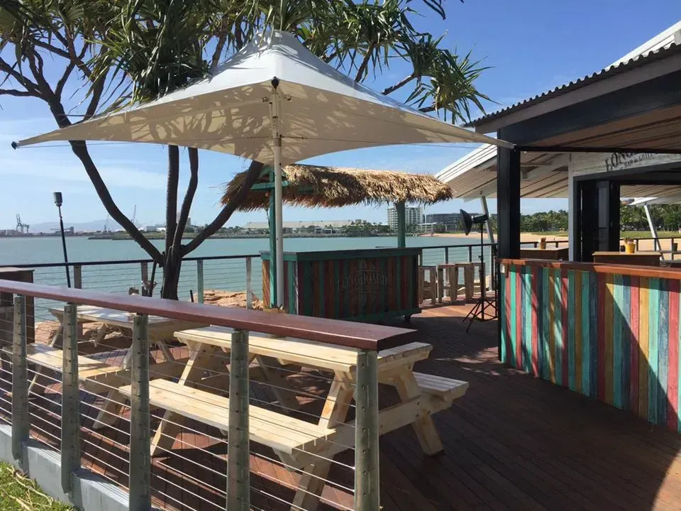 Seaside Store with an Umbrella Shade — Professional Shade Sail Installation in Townsville, QLD