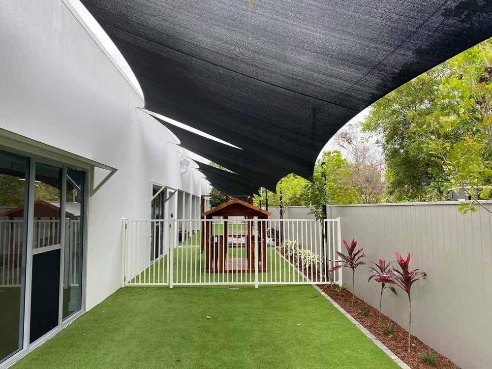 Shade Sail in a Grass Area — Professional Shade Sail Installation in Garbutt, QLD
