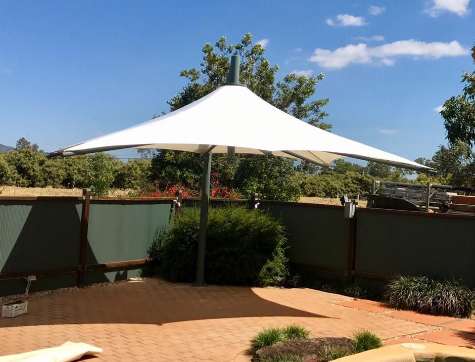 Small Fenced Area with an Umbrella Shade — Professional Shade Sail Installation in Garbutt, QLD