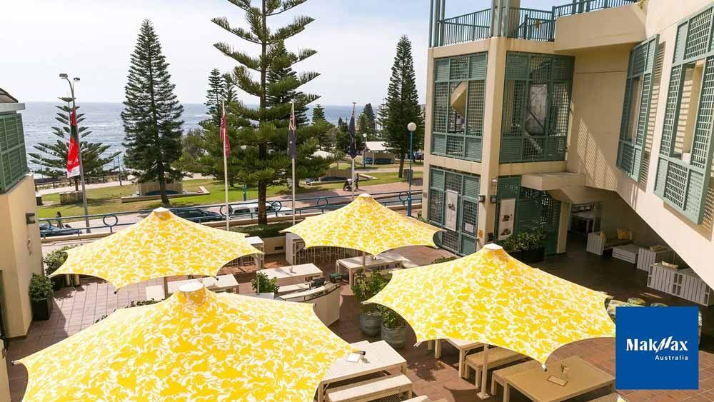 Yellow Umbrellas Used for Cover — Professional Shade Sail Installation in Garbutt, QLD