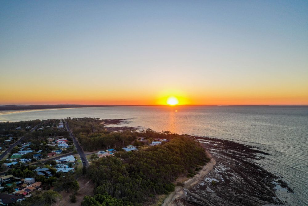 Sunset Over a Coastal Town — Professional Shade Sail Installation in Caloundra, QLD