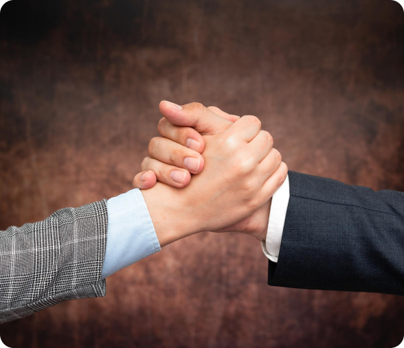 A man and a woman are shaking hands in front of a brown background