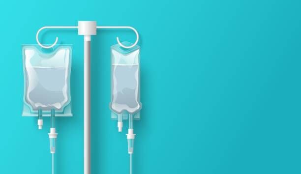 Two bags of iv fluid are hanging from a pole on a blue background.