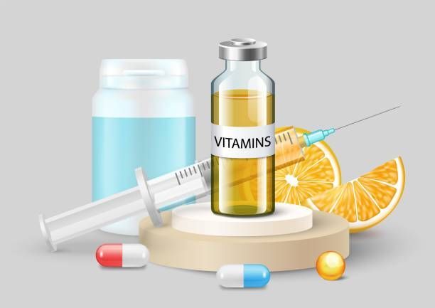 A bottle of vitamins , a syringe , pills , and an orange slice on a podium.