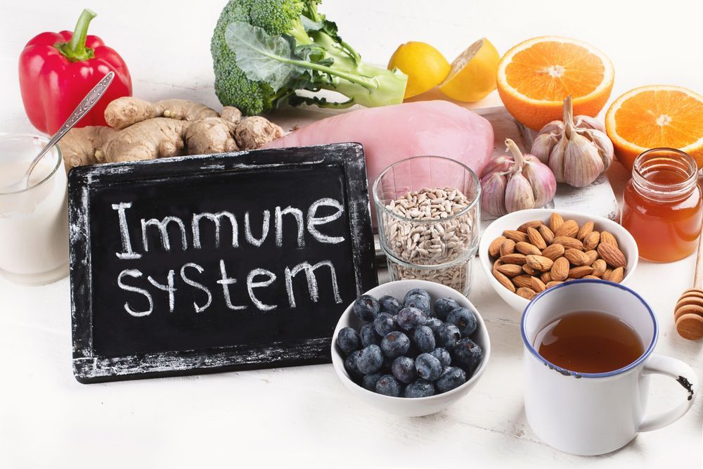 A chalkboard with the words `` immune system '' written on it is surrounded by bowls of fruits and vegetables.