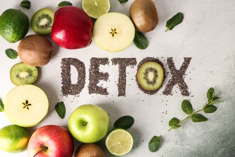 The word detox is written in seeds surrounded by fruit.