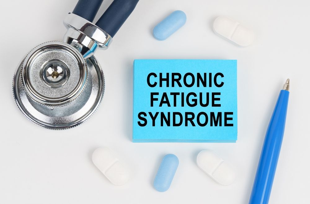 A stethoscope , pills , and a note that says chronic fatigue syndrome