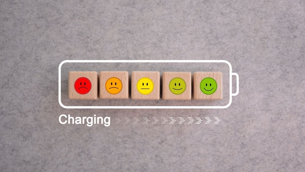 A row of wooden blocks with smiley faces on them are charging.