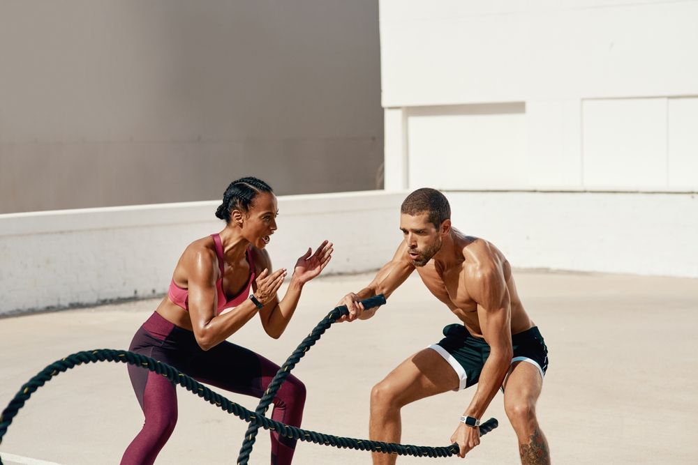 A man and a woman are playing with ropes.