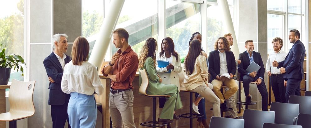 A group of people are standing and sitting in a room.