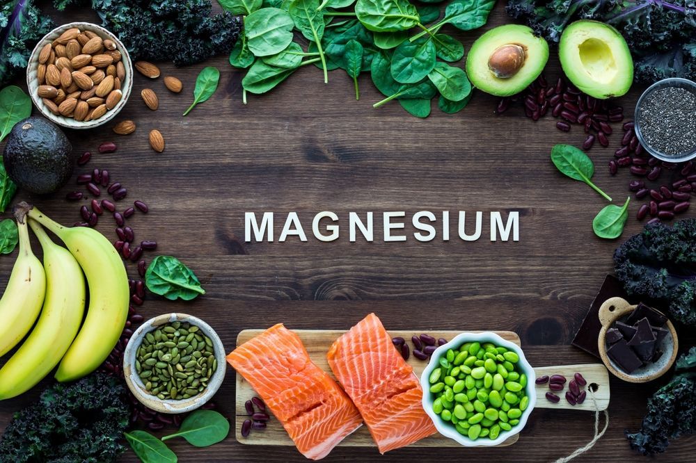 A wooden table topped with a variety of foods containing magnesium.