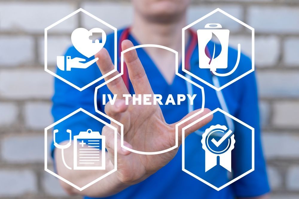 A nurse is pressing a button on a screen that says iv therapy.