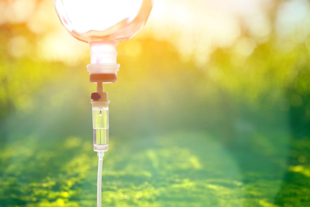 A close up of an intravenous drip with a blurred background.