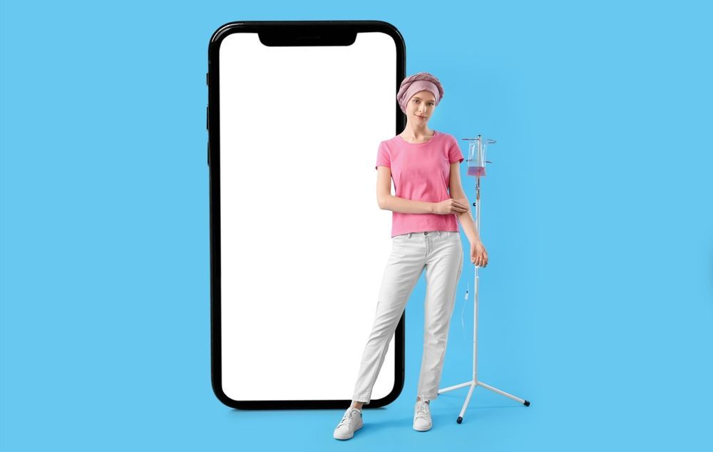 A woman with a drip in her arm is standing next to a cell phone.