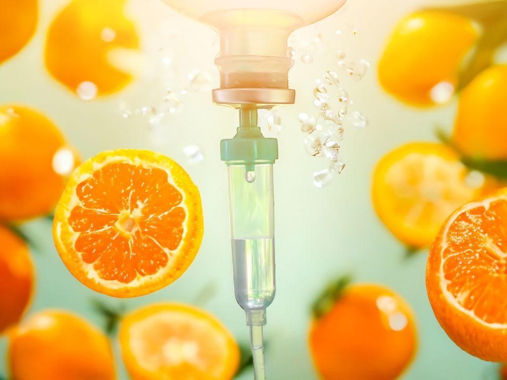 An orange slice is being injected into a syringe.