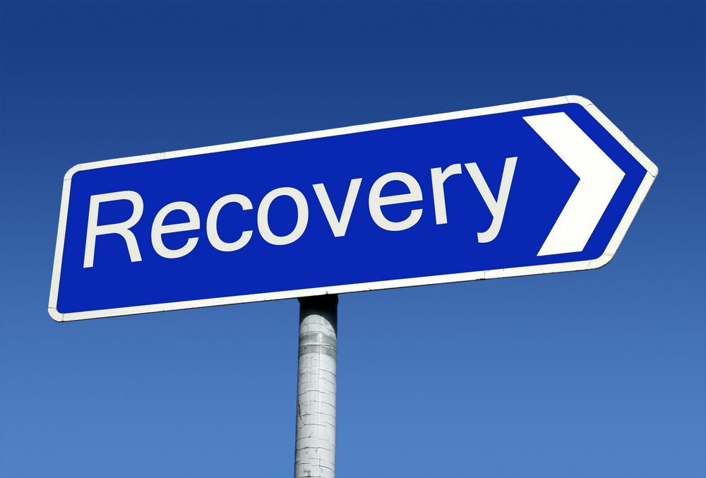 A blue street sign with the word recovery on it