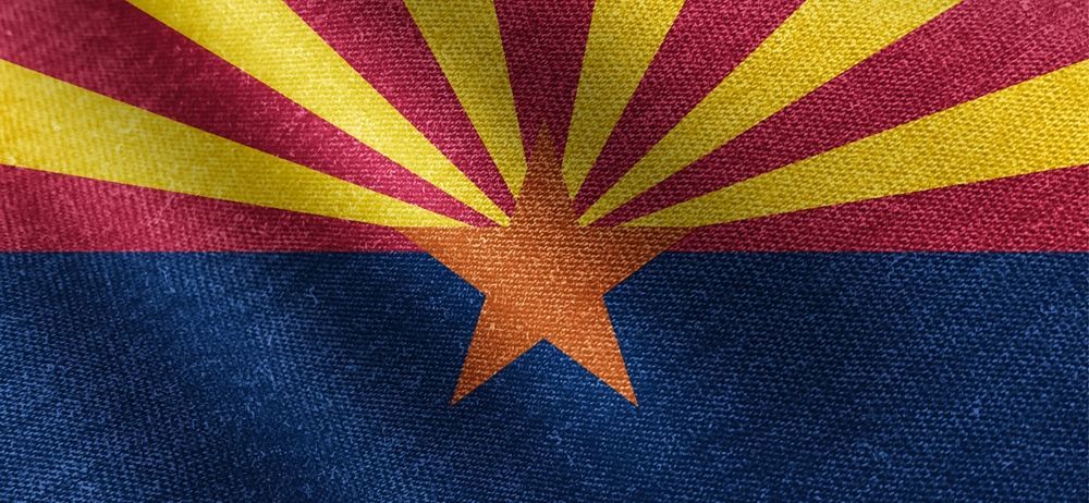 The flag of arizona is waving in the wind.