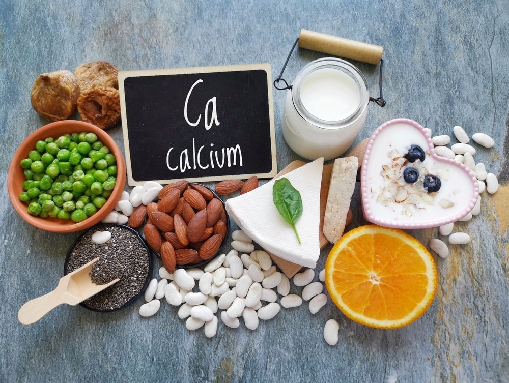 A table topped with a variety of foods containing calcium.