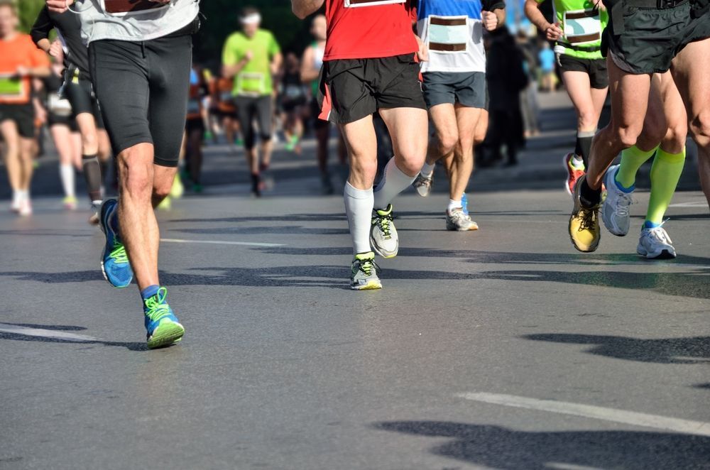 A group of people are running a marathon on a city street.