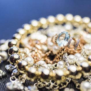 A close up of a pile of jewelry on a table.