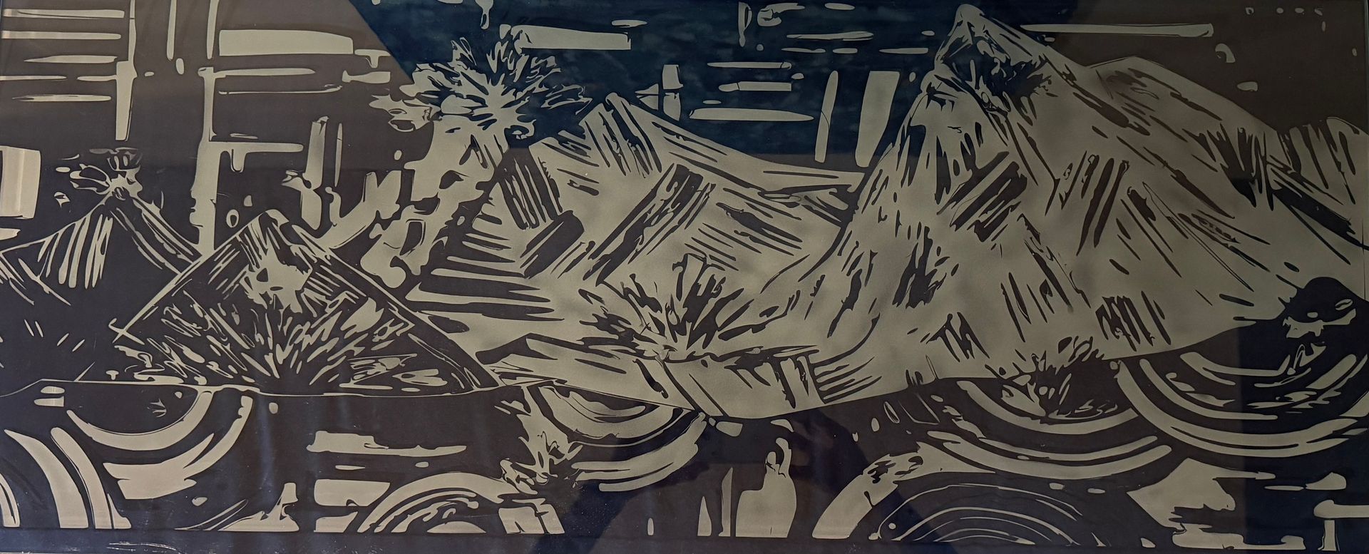 Bedroom with dark roller shades, a bed, and multiple windows. The walls are gray.