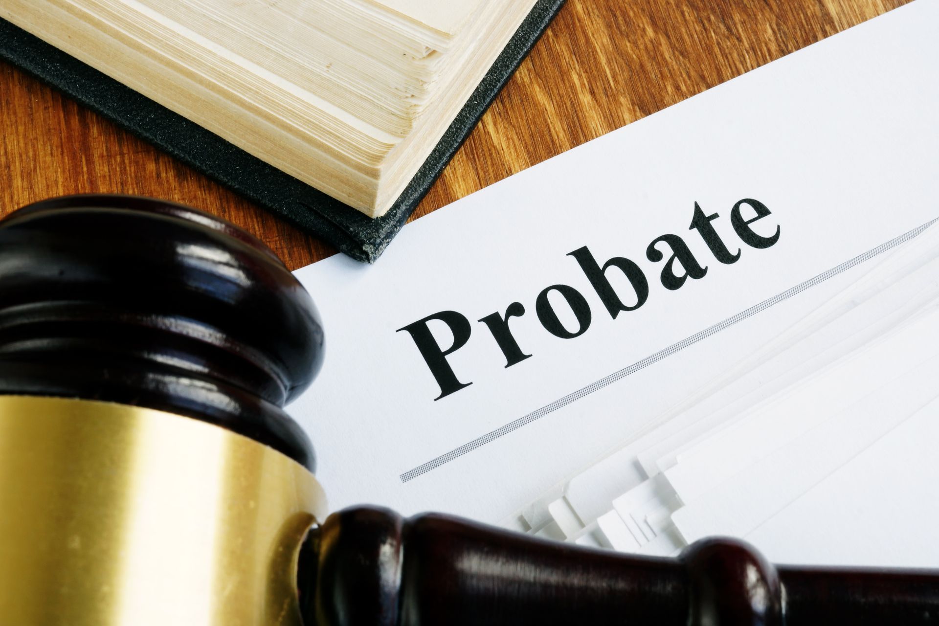 Close-up of a probate sign on a stack of papers and a wooden gavel.
