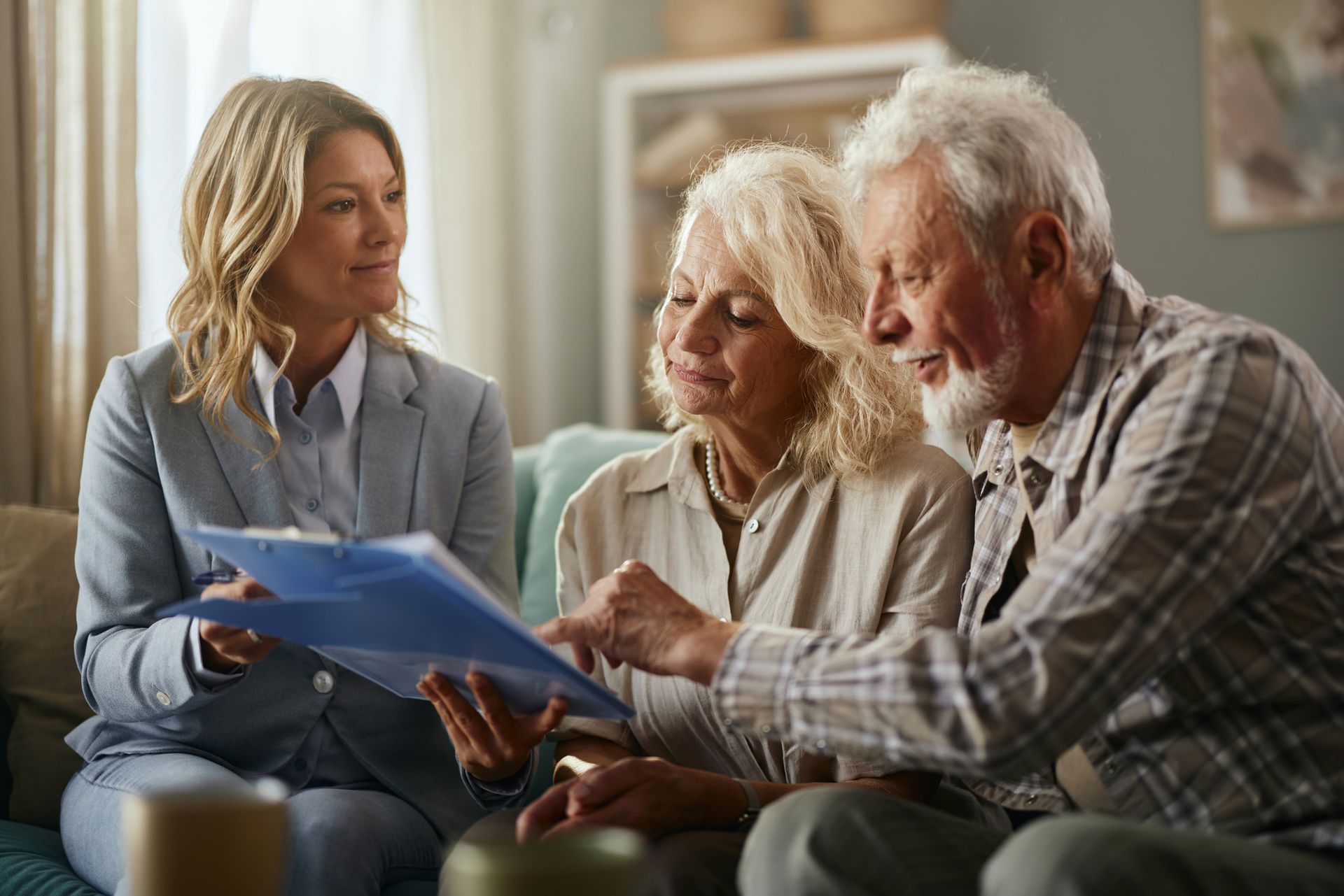 Smiling female lawyer and senior couple going through will