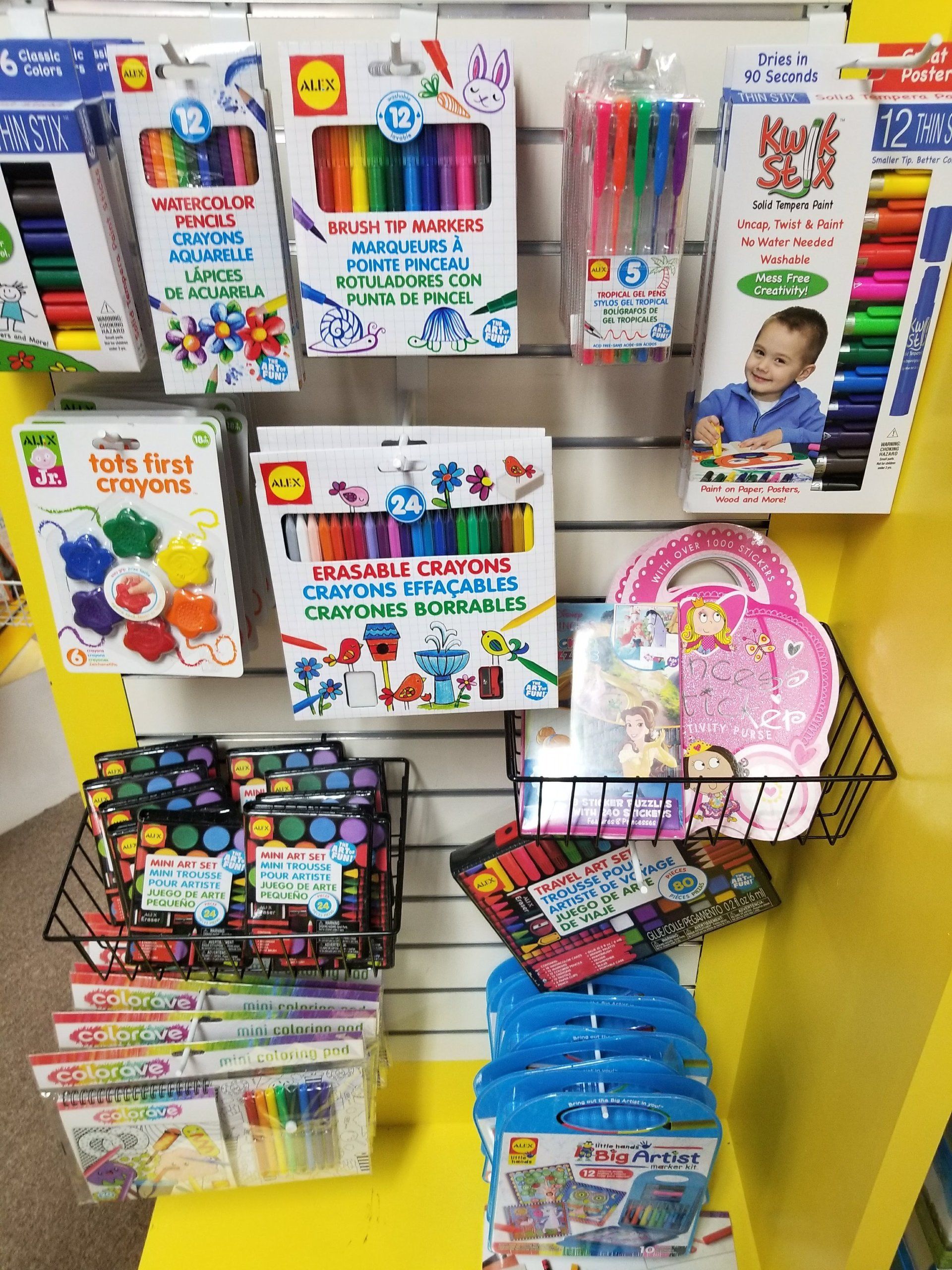 A variety of children 's toys are displayed on a wall in a store.
