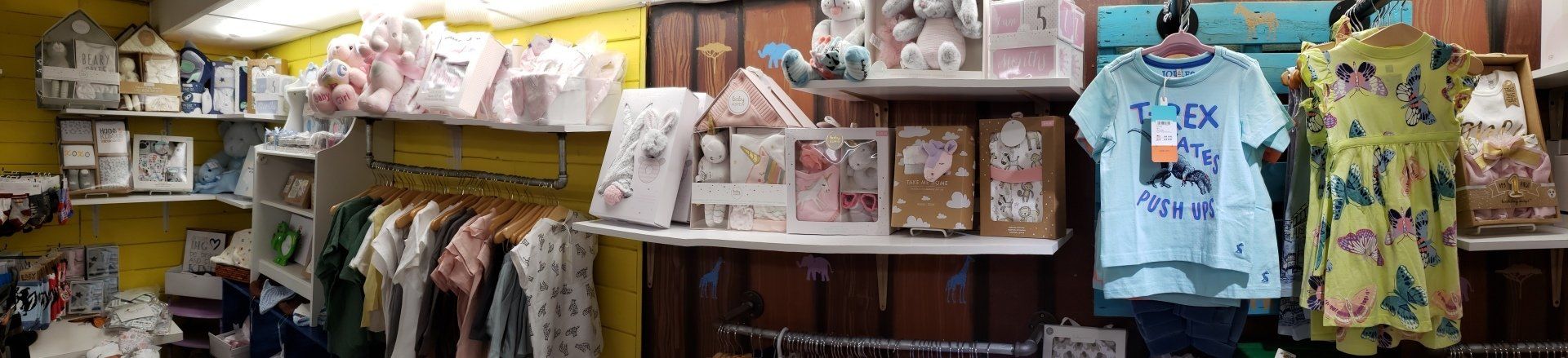 A store filled with lots of clothes hanging on racks.