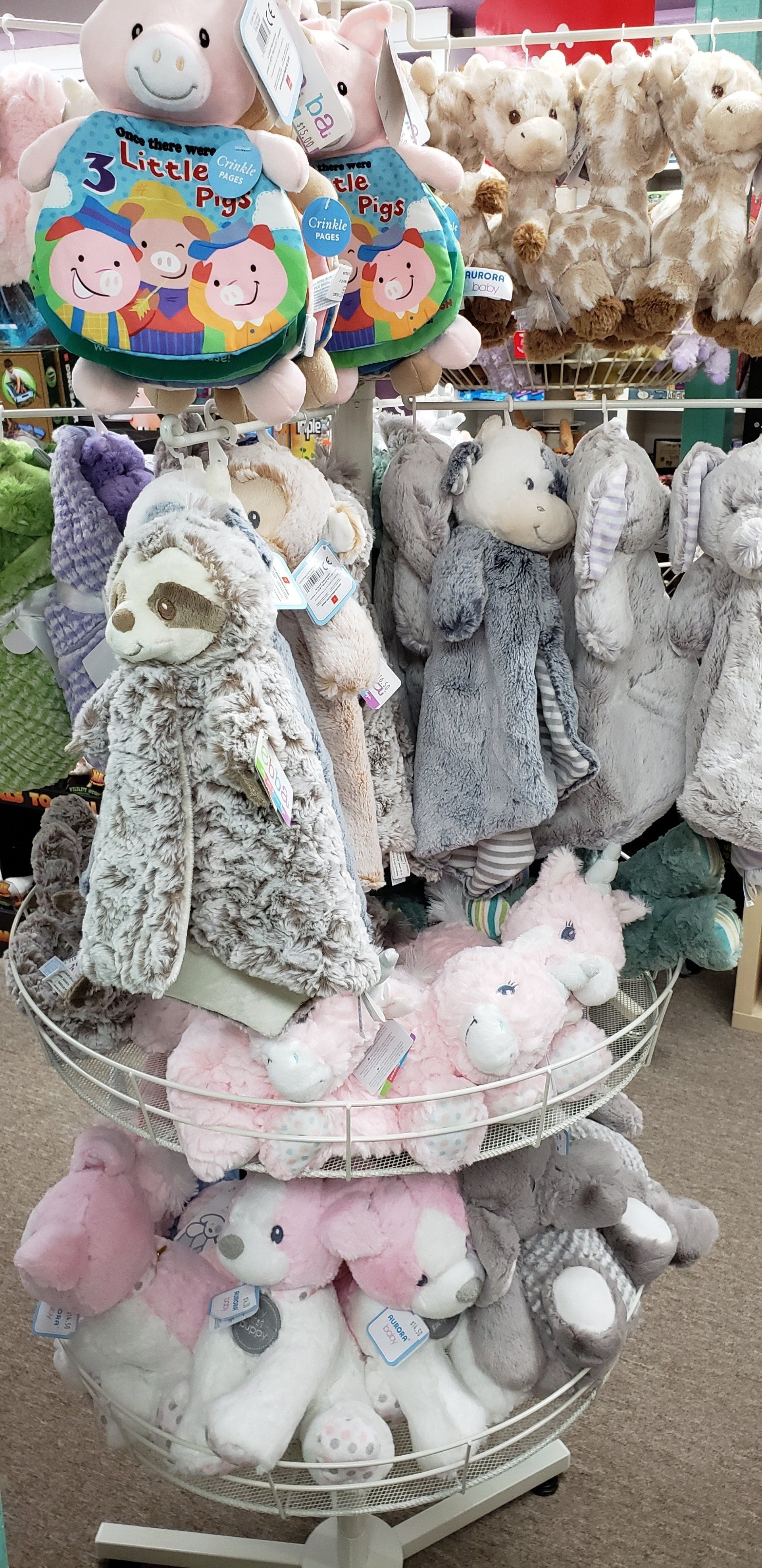 A display of stuffed animals on a stand in a store.