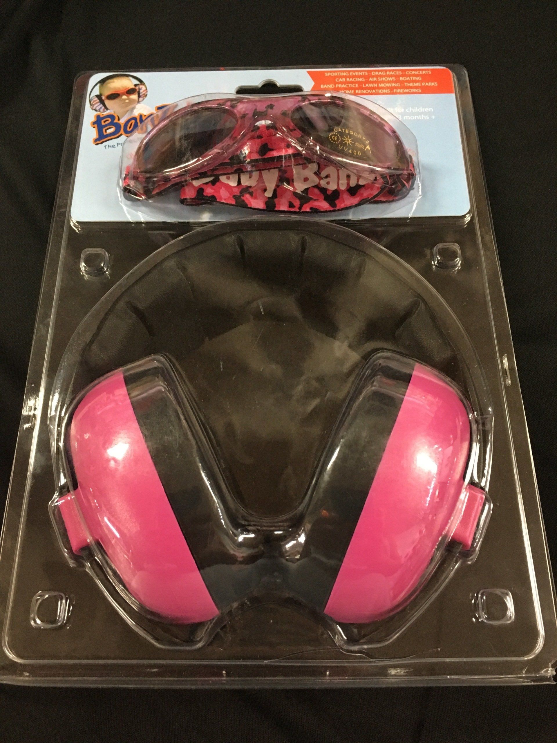 A pair of pink and black ear muffs in a package